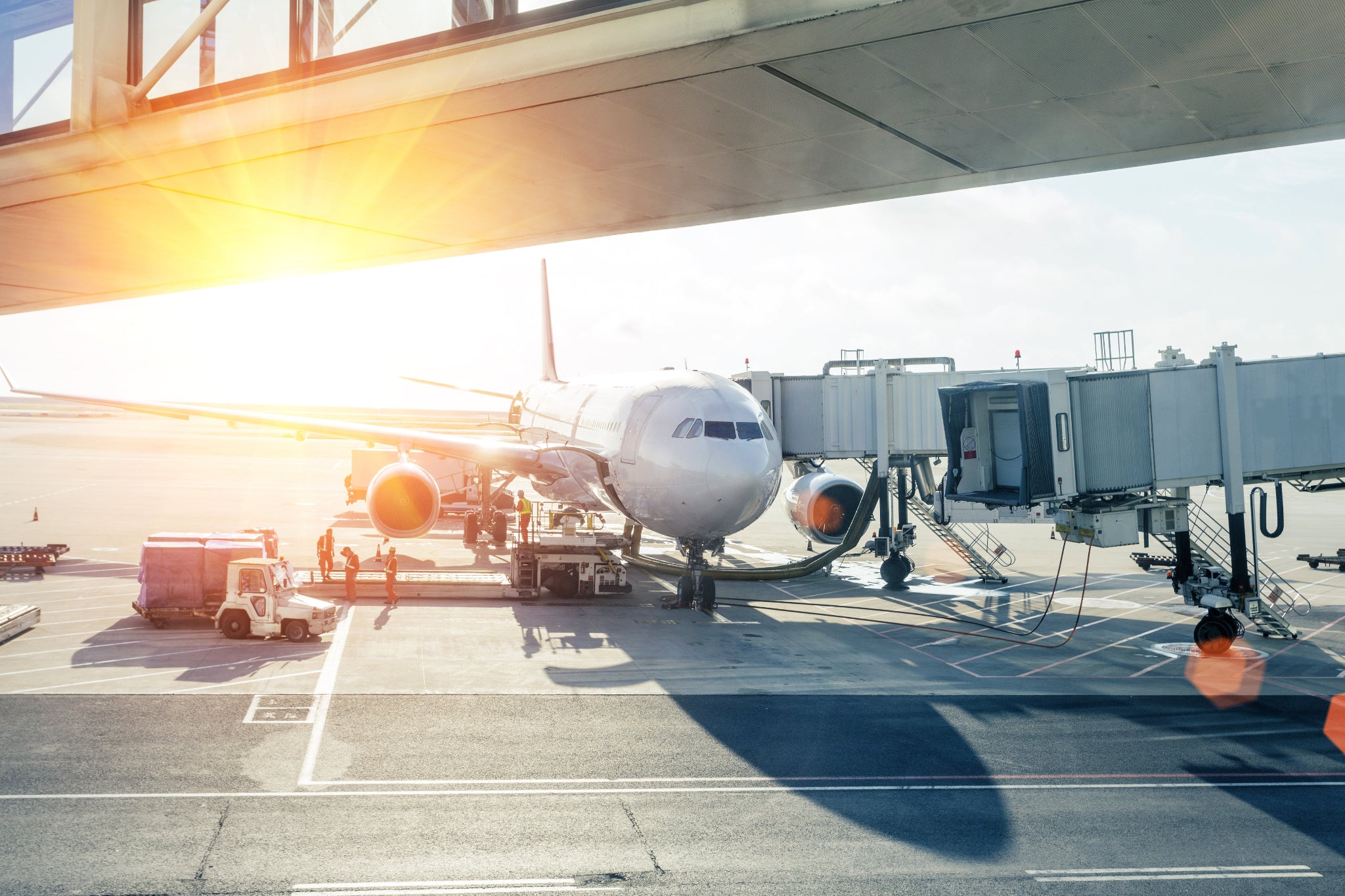 Airplane at an airport gate with a clear sky