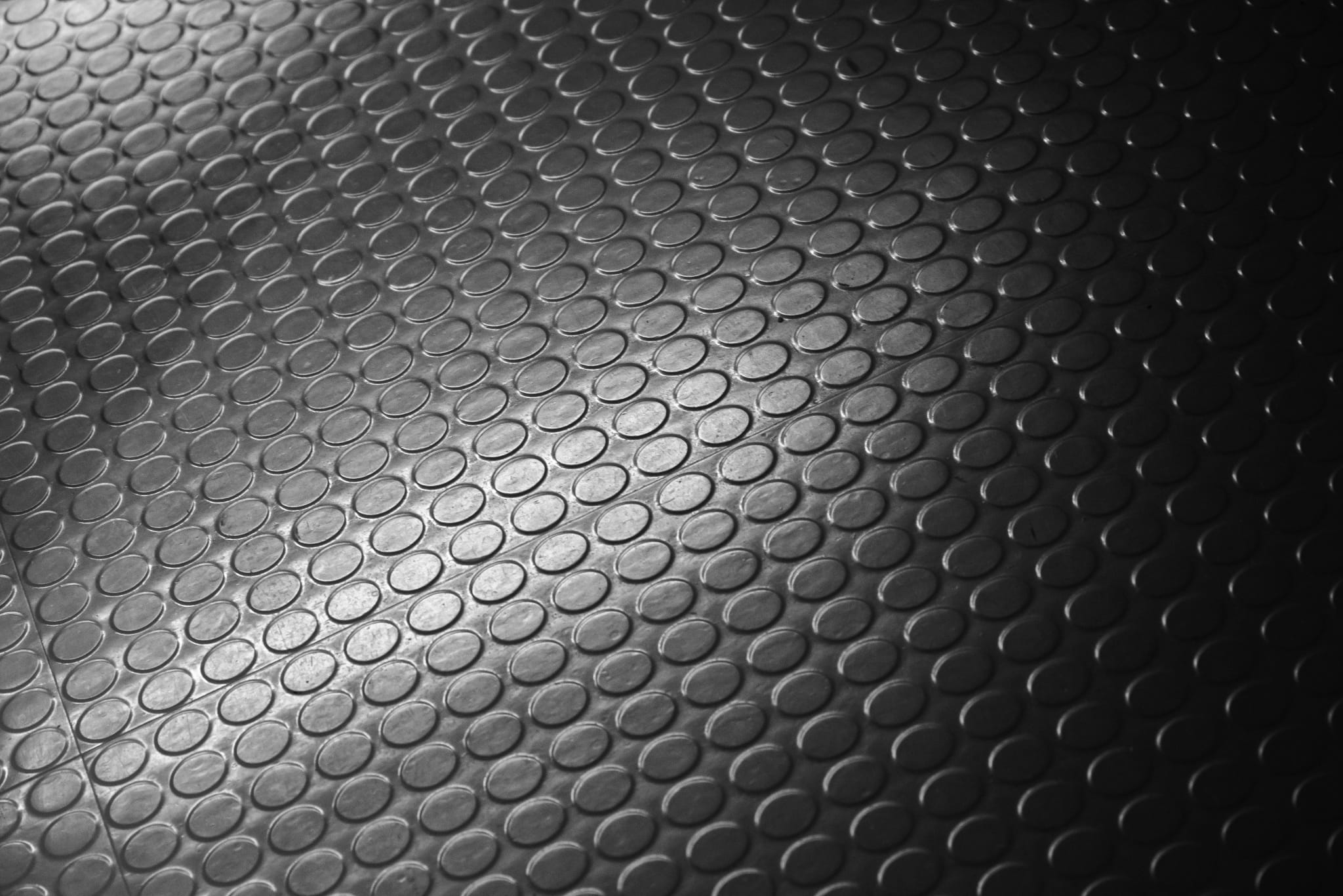 Close-up of a textured black surface with circular patterns