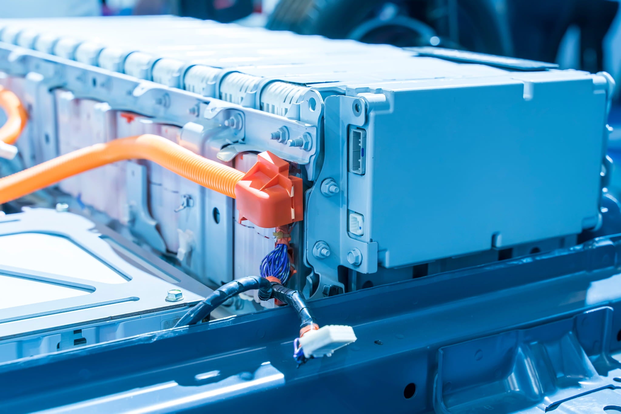 Close-up of a car battery pack with visible wiring and connectors.