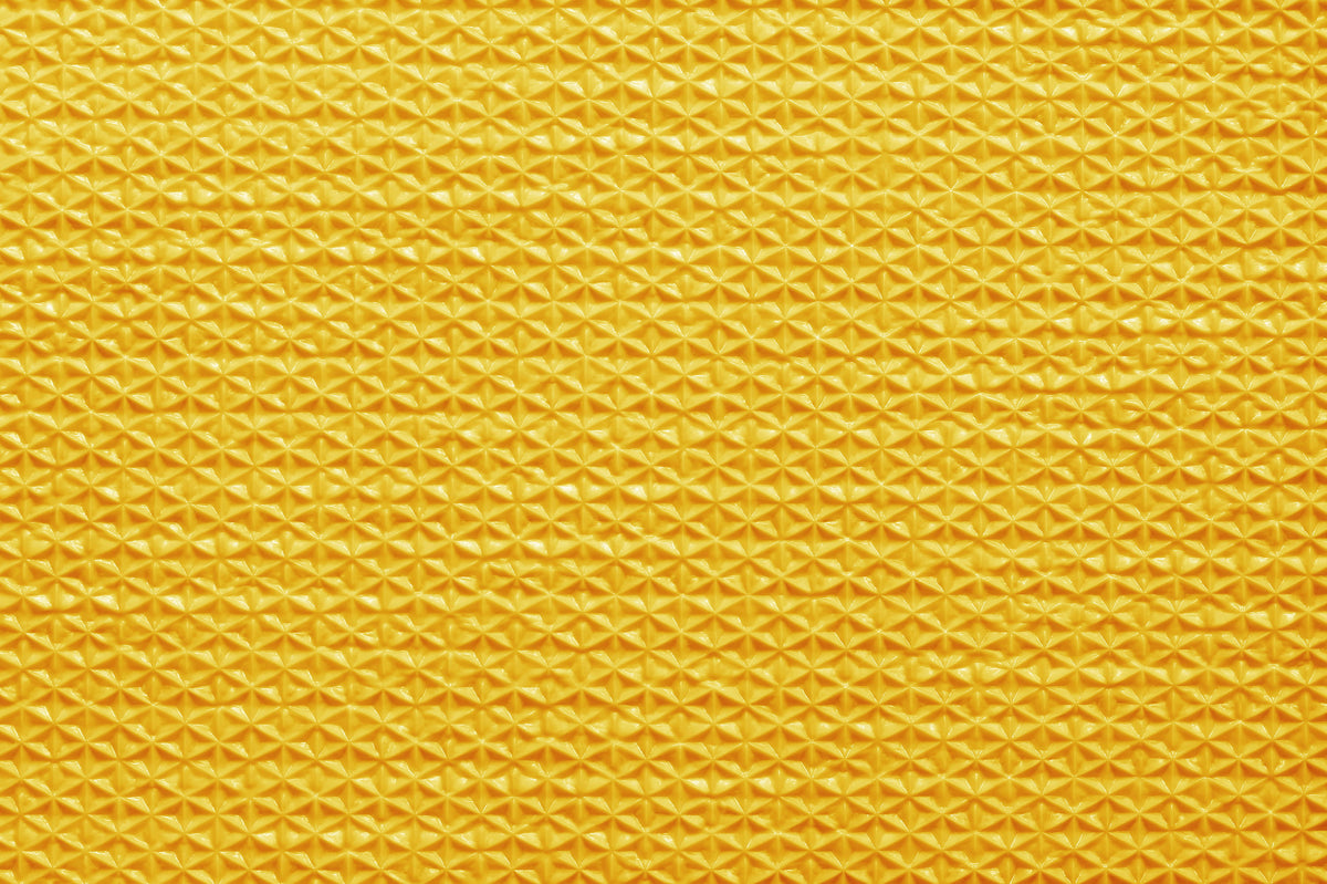 Close-up of a textured yellow fabric pattern
